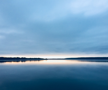 a body of water at sunrise