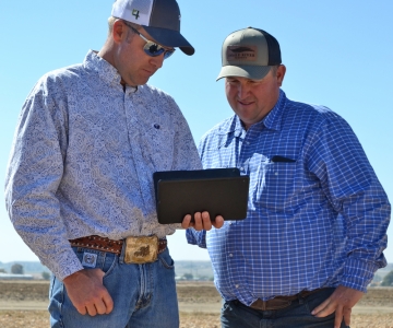 Two men viewing an iPad