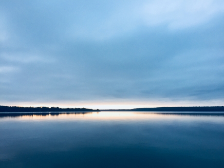 a body of water at sunrise