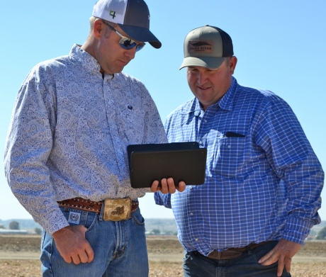 Two men viewing an iPad